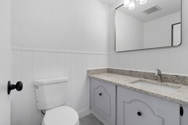 bathroom featuring toilet and vanity