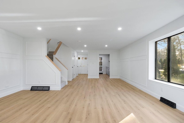 unfurnished living room featuring light hardwood / wood-style floors