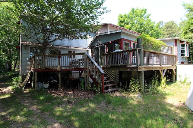 rear view of house featuring stairs and a wooden deck