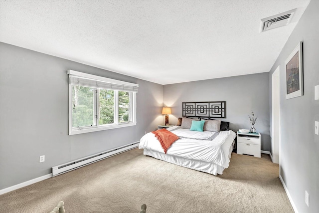 bedroom with baseboard heating, carpet, and a textured ceiling