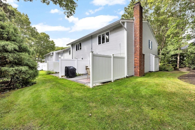 rear view of house featuring a lawn