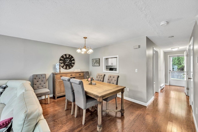 dining space with an inviting chandelier, dark hardwood / wood-style flooring, and a textured ceiling