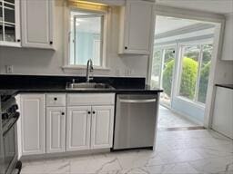 2 Spinning Brook Rd, South Yarmouth, MA 02664 - kitchen with stainless steel dishwasher, range, dark countertops, and white cabinetry