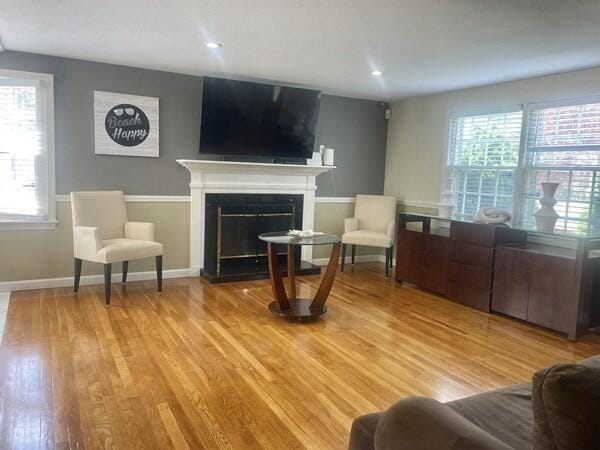 2 Spinning Brook Rd, South Yarmouth, MA 02664 - living area featuring light wood-type flooring and a fireplace with raised hearth