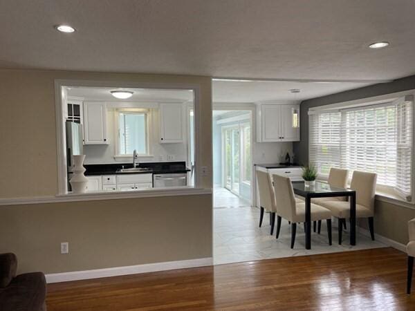 2 Spinning Brook Rd, South Yarmouth, MA 02664 - kitchen featuring white cabinetry, freestanding refrigerator, light wood-style floors, dark countertops, and recessed lighting