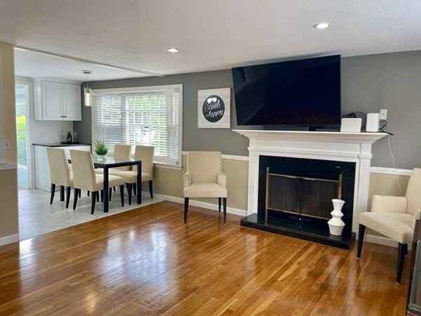 2 Spinning Brook Rd, South Yarmouth, MA 02664 - living room with light wood finished floors, a glass covered fireplace, and recessed lighting