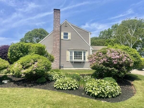 2 Spinning Brook Rd, South Yarmouth, MA 02664 - view of side of property featuring a chimney and a yard