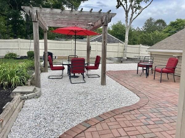 2 Spinning Brook Rd, South Yarmouth, MA 02664 - fenced backyard featuring a pergola and a patio