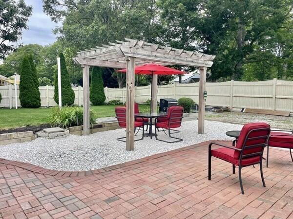 2 Spinning Brook Rd, South Yarmouth, MA 02664 - fenced backyard with a pergola and a patio area