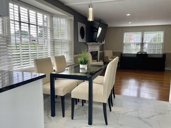 2 Spinning Brook Rd, South Yarmouth, MA 02664 - dining room featuring a fireplace, marble look tile flooring, and recessed lighting