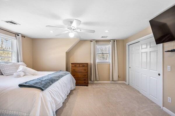 2 Spinning Brook Rd, South Yarmouth, MA 02664 - bedroom featuring multiple windows, light carpet, ceiling fan, a closet, and recessed lighting