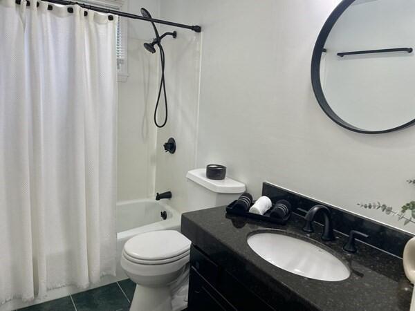 2 Spinning Brook Rd, South Yarmouth, MA 02664 - full bathroom featuring tile patterned flooring, shower / bath combo with shower curtain, and vanity