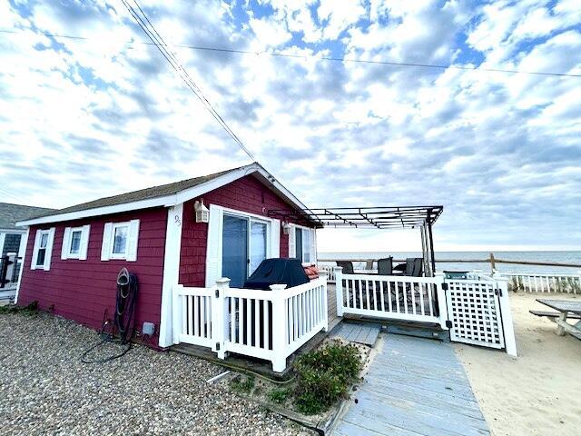 exterior space with a deck with water view