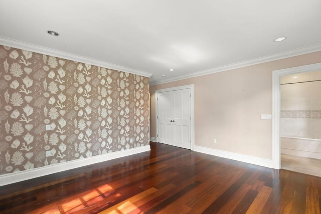 unfurnished room with ornamental molding and hardwood / wood-style floors