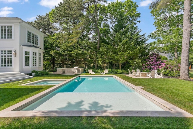 view of pool featuring a patio area, a yard, and a fire pit