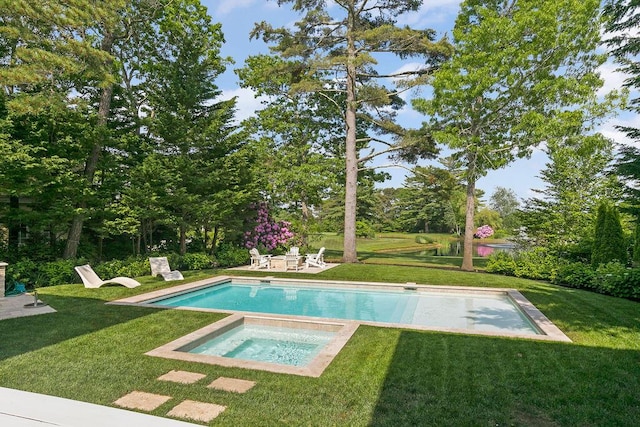 view of pool with an in ground hot tub and a yard