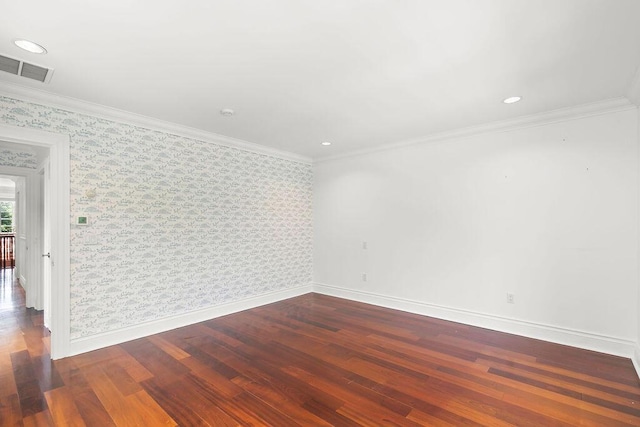 spare room with dark wood-type flooring and ornamental molding