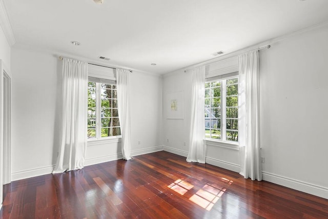 unfurnished room featuring hardwood / wood-style flooring and crown molding