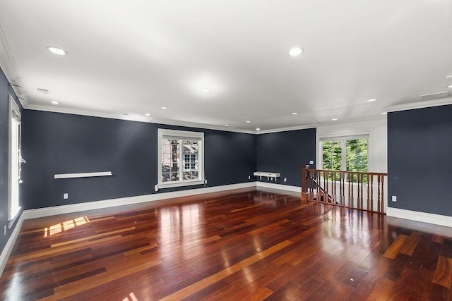 unfurnished room with hardwood / wood-style floors and crown molding