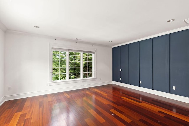 unfurnished room featuring crown molding and dark hardwood / wood-style floors