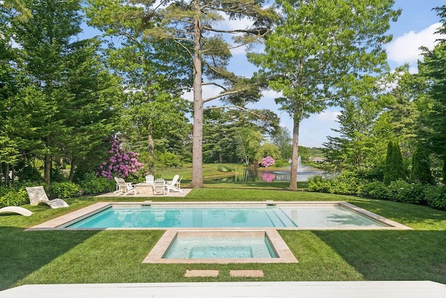 view of swimming pool featuring a lawn, an in ground hot tub, and a water view