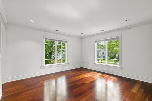 empty room featuring ornamental molding and dark hardwood / wood-style flooring