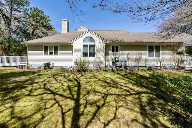 12 Kettle Ln, Mashpee, MA 02649 - rear view of house with a chimney, a yard, and a deck