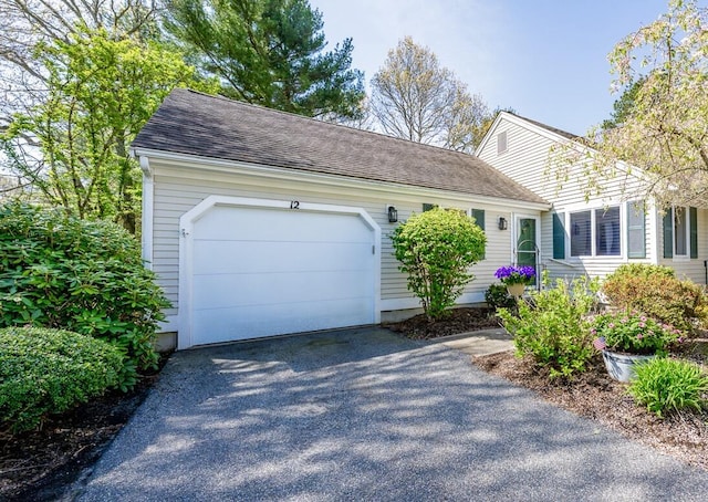12 Kettle Ln, Mashpee, MA 02649 - view of front of house with driveway, a garage, and a shingled roof