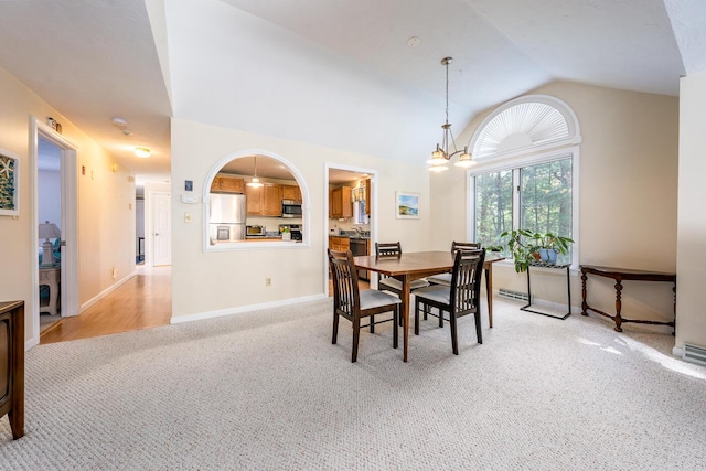 12 Kettle Ln, Mashpee, MA 02649 - dining space featuring light colored carpet, vaulted ceiling, a chandelier, and baseboards