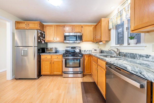 12 Kettle Ln, Mashpee, MA 02649 - kitchen with stainless steel appliances, light stone counters, light wood-style floors, and a sink