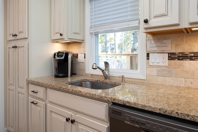 56 S Yarmouth Rd, Dennis, MA 02638 - kitchen featuring dishwasher, a sink, decorative backsplash, light stone countertops, and white cabinets