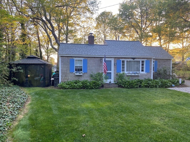 9 Bayberry Ln, South Dennis, MA 02660 - view of front facade featuring a chimney, a gazebo, a front lawn, and a shingled roof