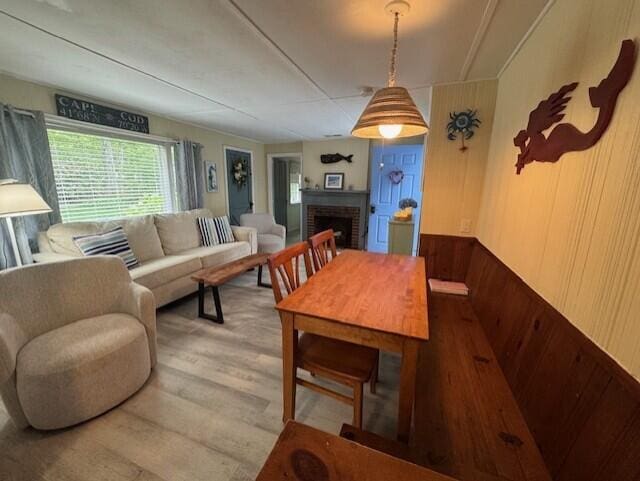 9 Bayberry Ln, South Dennis, MA 02660 - living room featuring wood finished floors, a brick fireplace, and wood walls