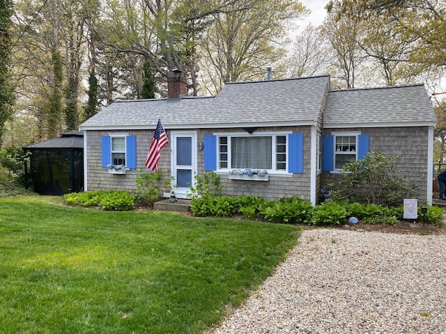 9 Bayberry Ln, South Dennis, MA 02660 - view of front of home with a front yard, a chimney, a shingled roof, and a gazebo