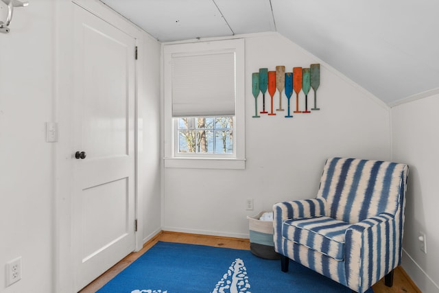 sitting room with hardwood / wood-style floors and lofted ceiling