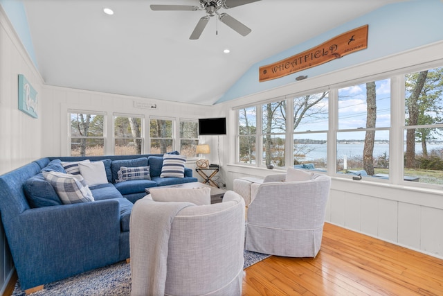 living room with vaulted ceiling, ceiling fan, and wood-type flooring