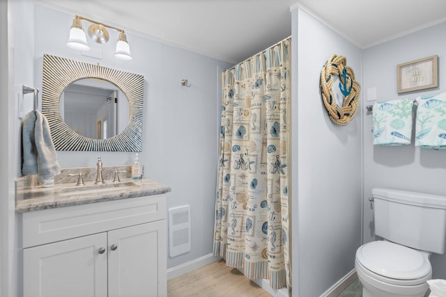 bathroom with vanity, toilet, ornamental molding, and wood-type flooring