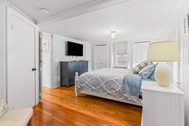 bedroom featuring hardwood / wood-style floors and ornamental molding