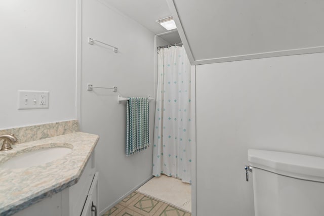 bathroom with toilet, walk in shower, and vanity