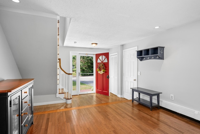 65 Hadrada Ln, Centerville, MA 02632 - foyer featuring wood-type flooring, a textured ceiling, recessed lighting, wine cooler, and stairway