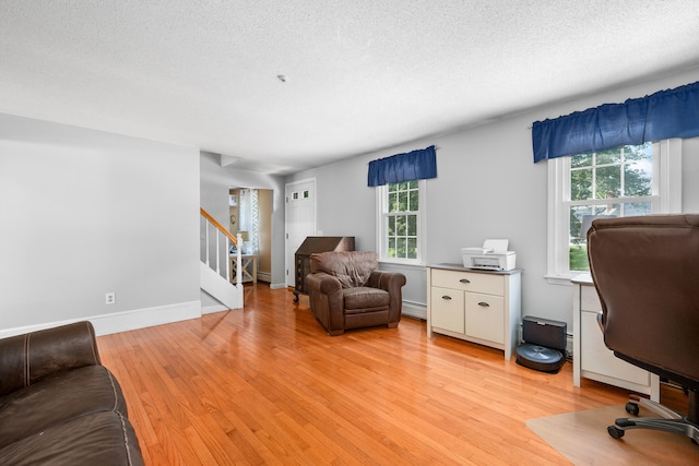 65 Hadrada Ln, Centerville, MA 02632 - office space with light wood finished floors, a textured ceiling, and a baseboard radiator