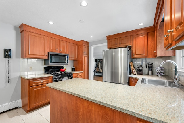 65 Hadrada Ln, Centerville, MA 02632 - kitchen featuring stainless steel appliances, a baseboard radiator, a peninsula, decorative backsplash, and light tile patterned floors