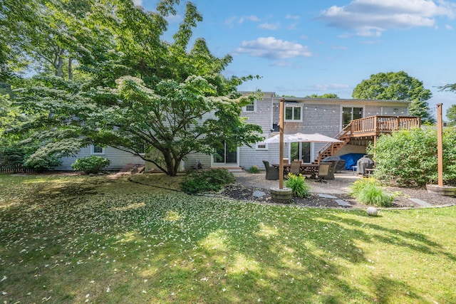 65 Hadrada Ln, Centerville, MA 02632 - back of property with a lawn, a wooden deck, and a patio area
