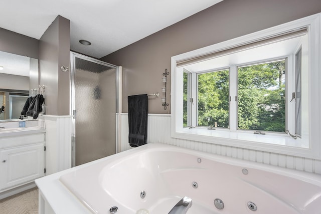 65 Hadrada Ln, Centerville, MA 02632 - bathroom with a wainscoted wall, a stall shower, a tub with jets, and vanity