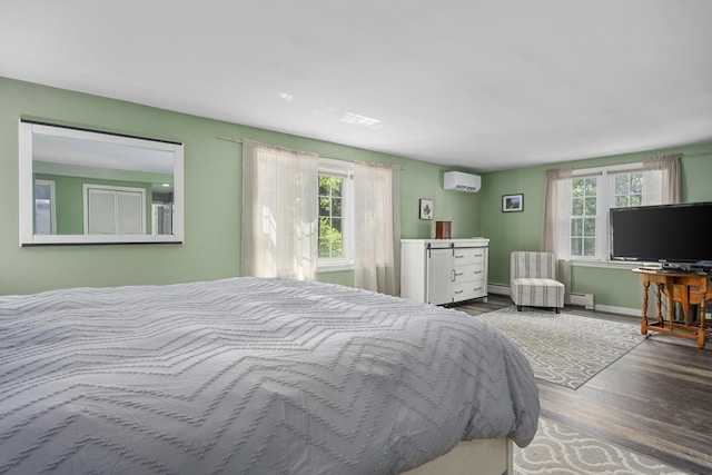 65 Hadrada Ln, Centerville, MA 02632 - bedroom with a wall unit AC, multiple windows, wood finished floors, and a baseboard radiator