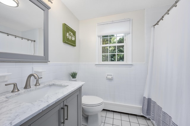 65 Hadrada Ln, Centerville, MA 02632 - full bathroom with a baseboard radiator, tile walls, tile patterned floors, vanity, and a wainscoted wall