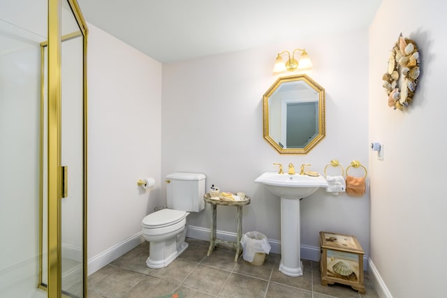 bathroom with toilet and tile patterned floors