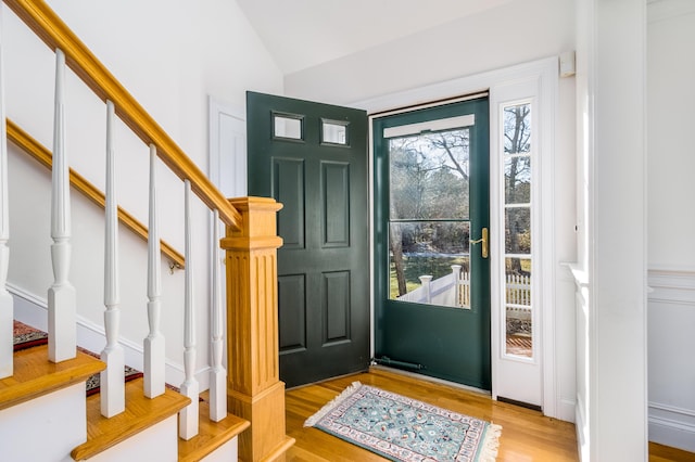 foyer with light hardwood / wood-style floors and lofted ceiling