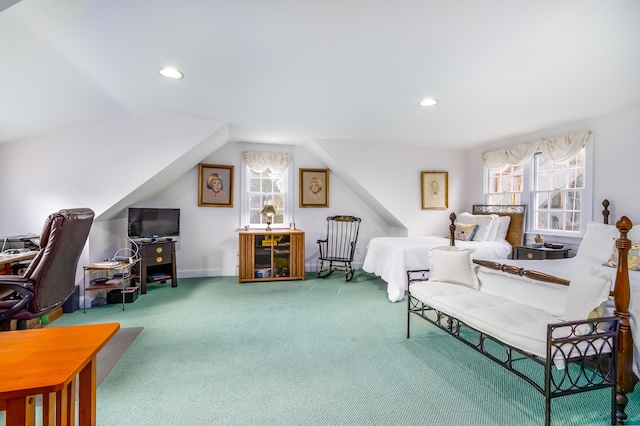 bedroom with multiple windows, vaulted ceiling, and carpet flooring