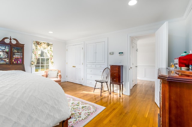 bedroom with light wood-type flooring and ornamental molding